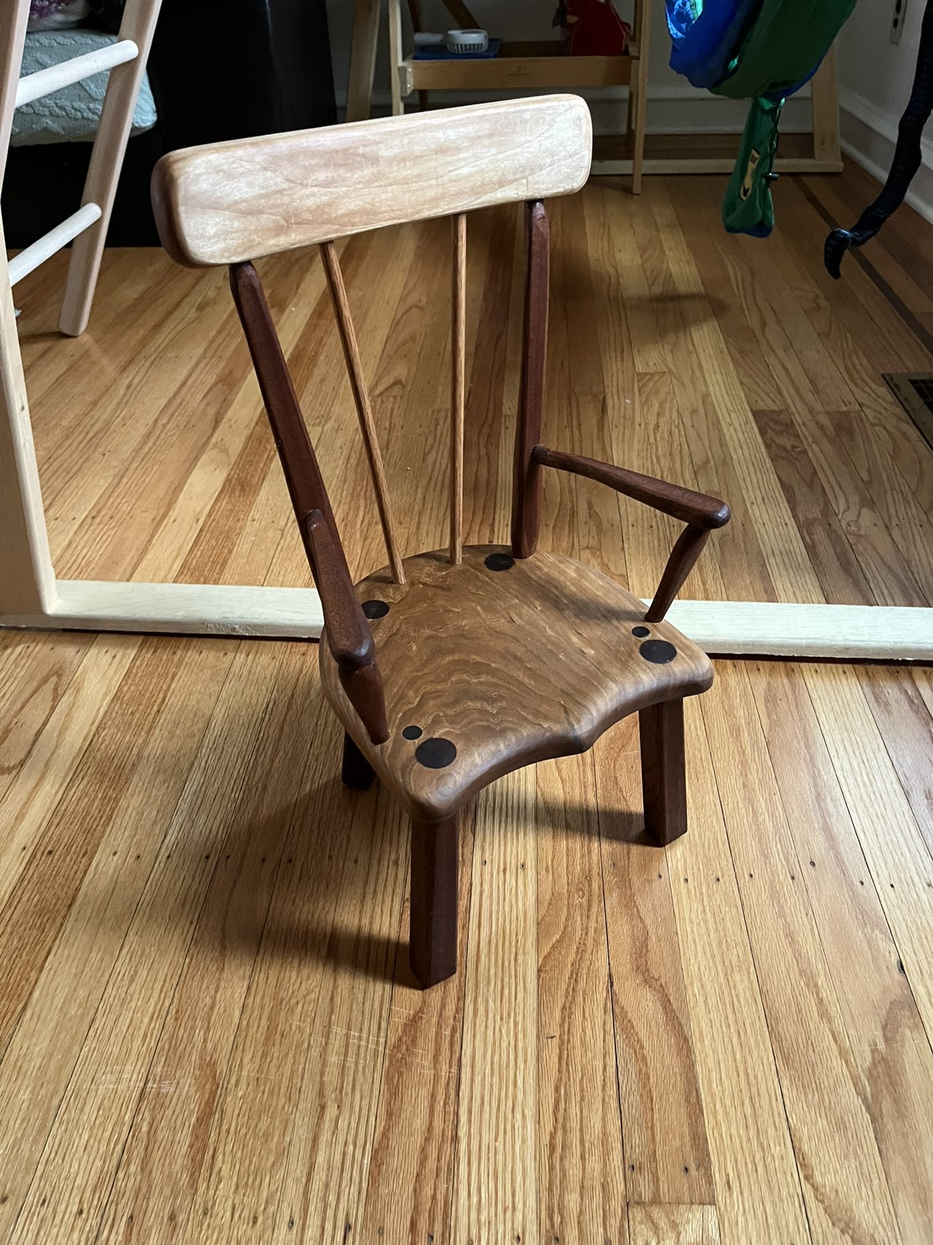 Finished wooden stick chair with shaped seat and broad backrest