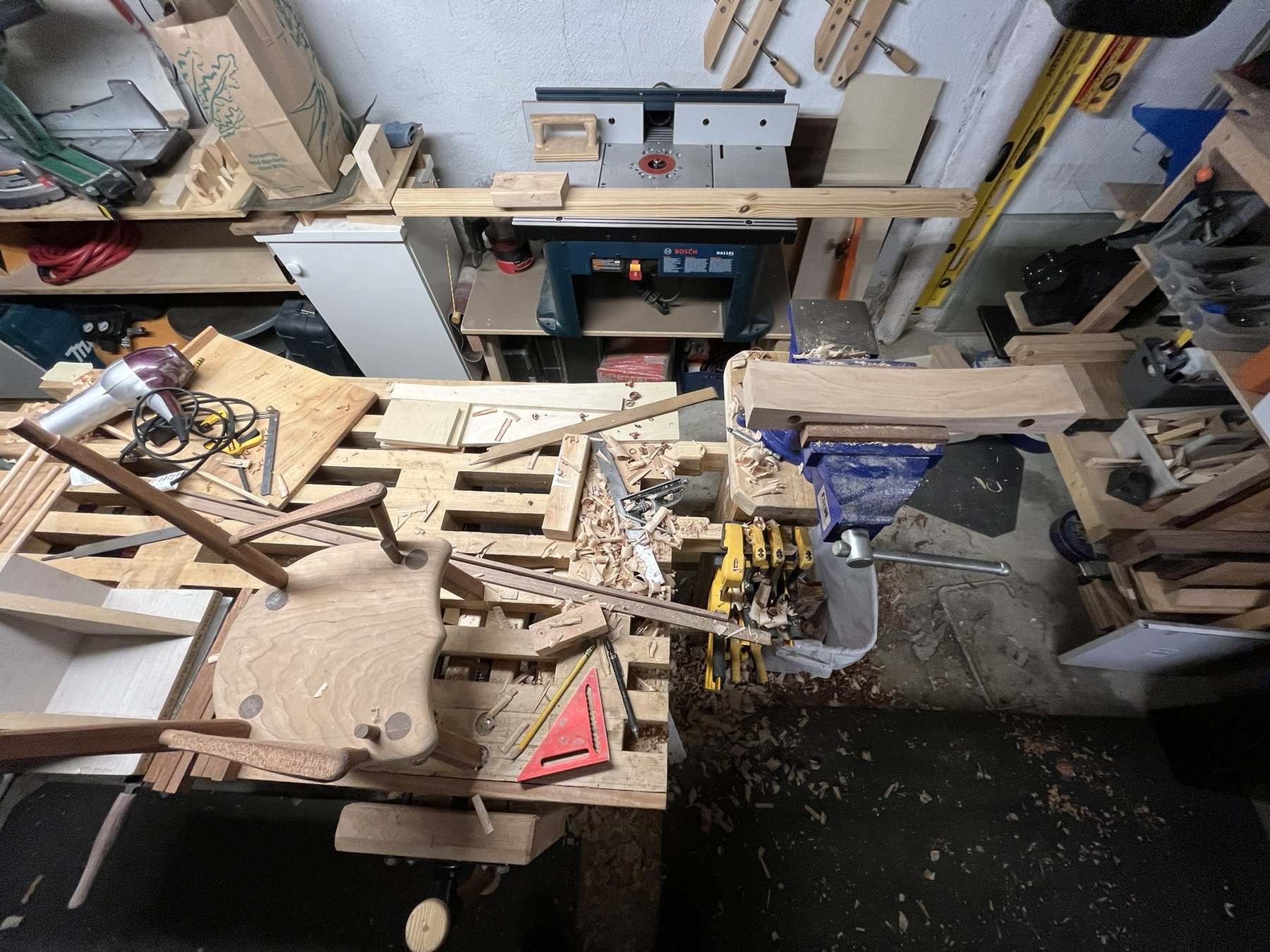 Shaped wooden chair seat with sticks during bench assembly