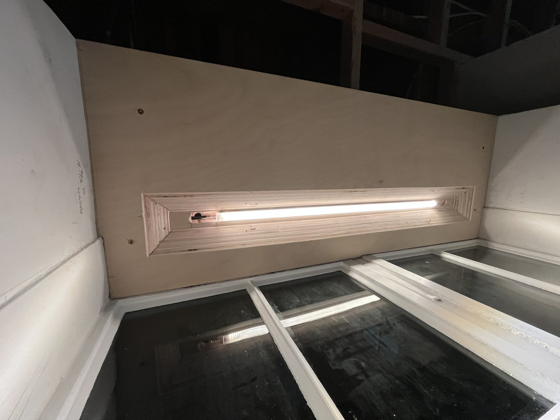 Light emitter recessed into an angled opening above a window