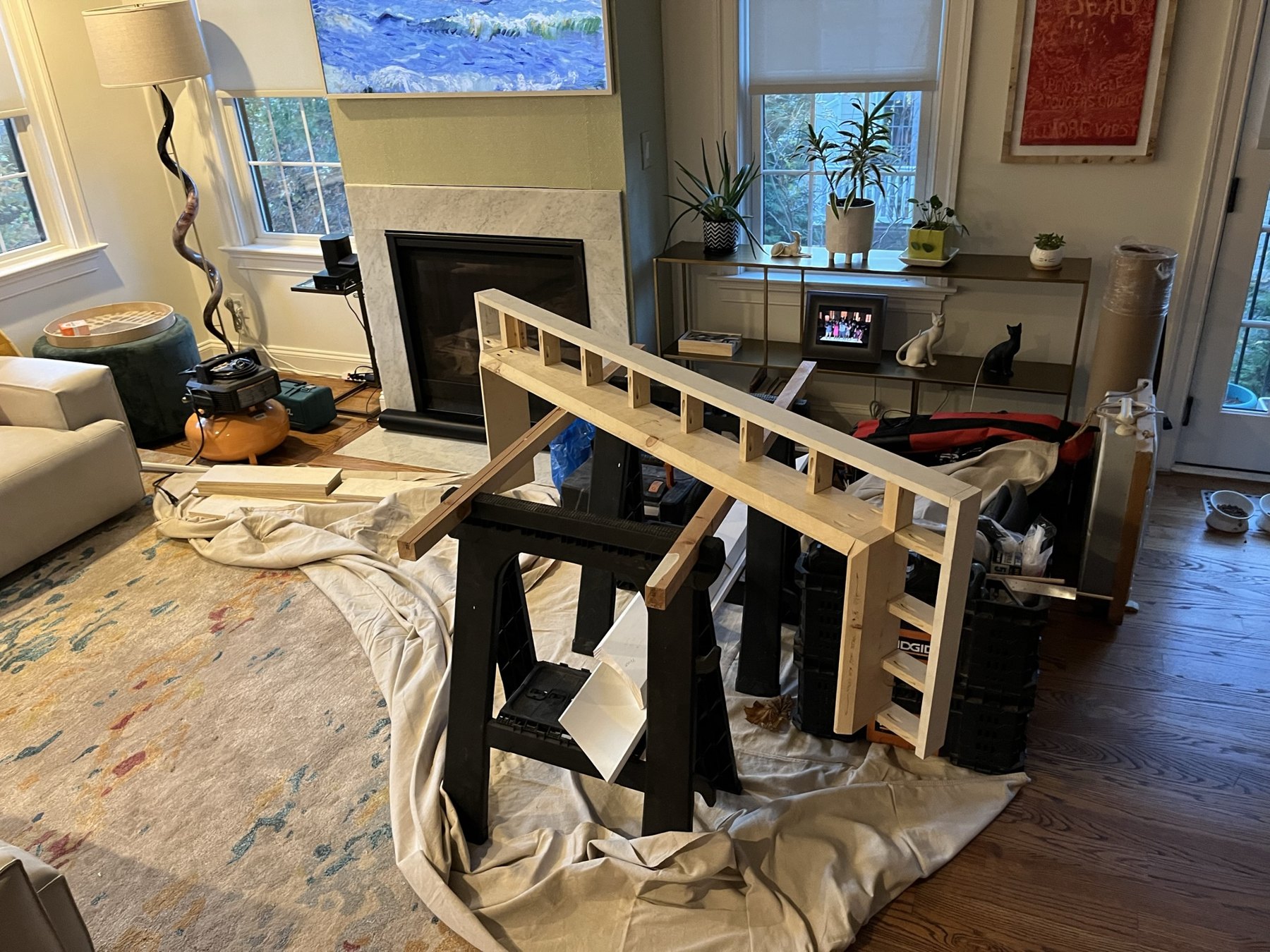 Mantel assembly positioned in front of the fireplace during installation