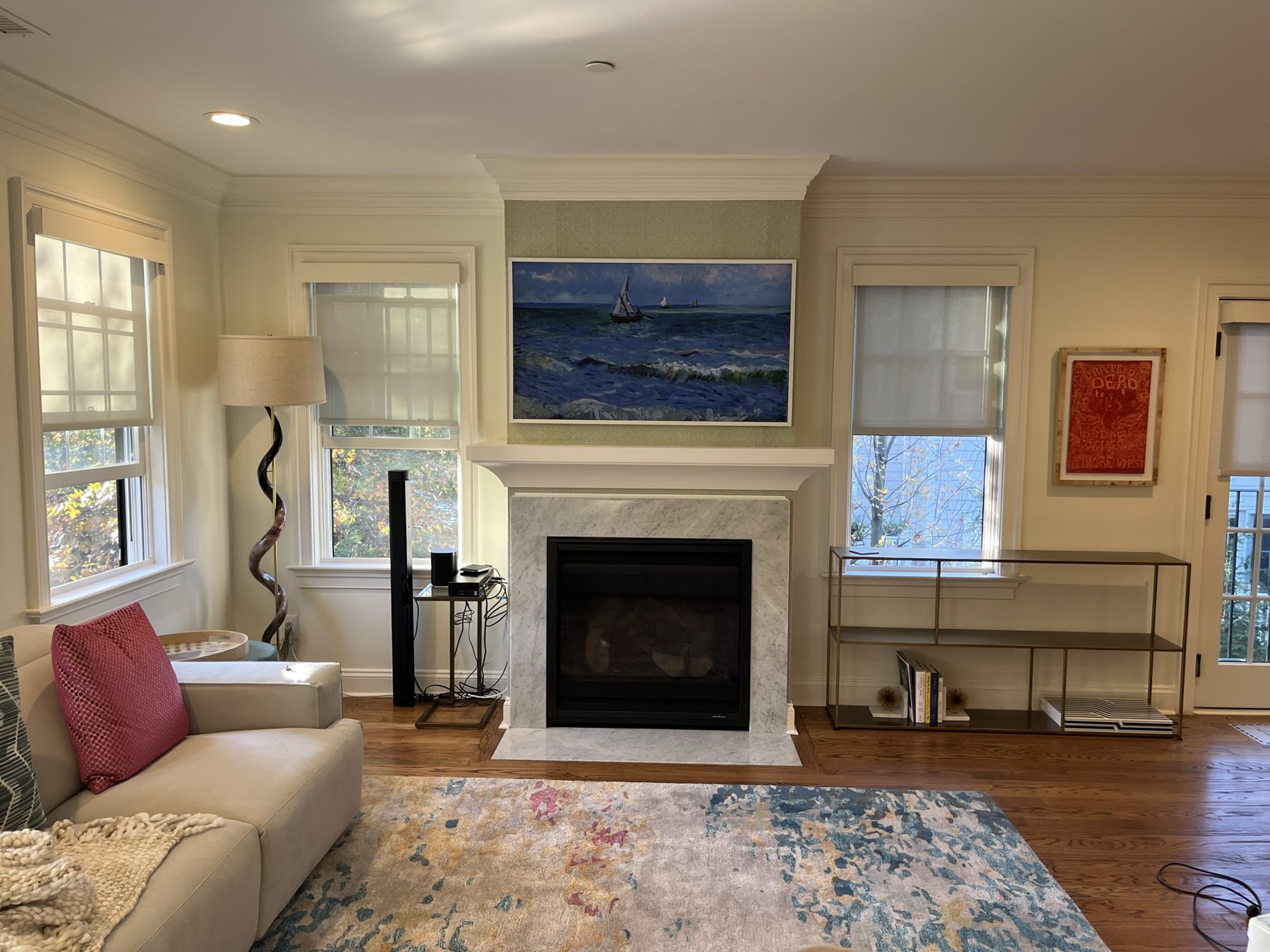 White mantel around a fireplace in a furnished living room