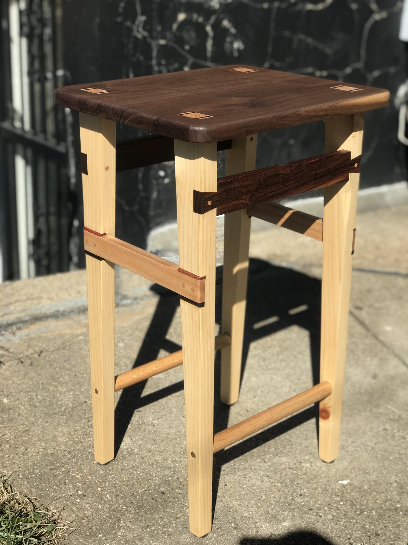 Wood kitchen stool with a dark seat and contrasting legs