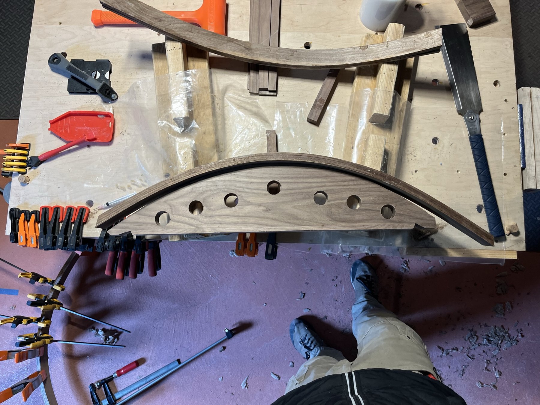 Laminated curved wood trim held in clamps on the workbench