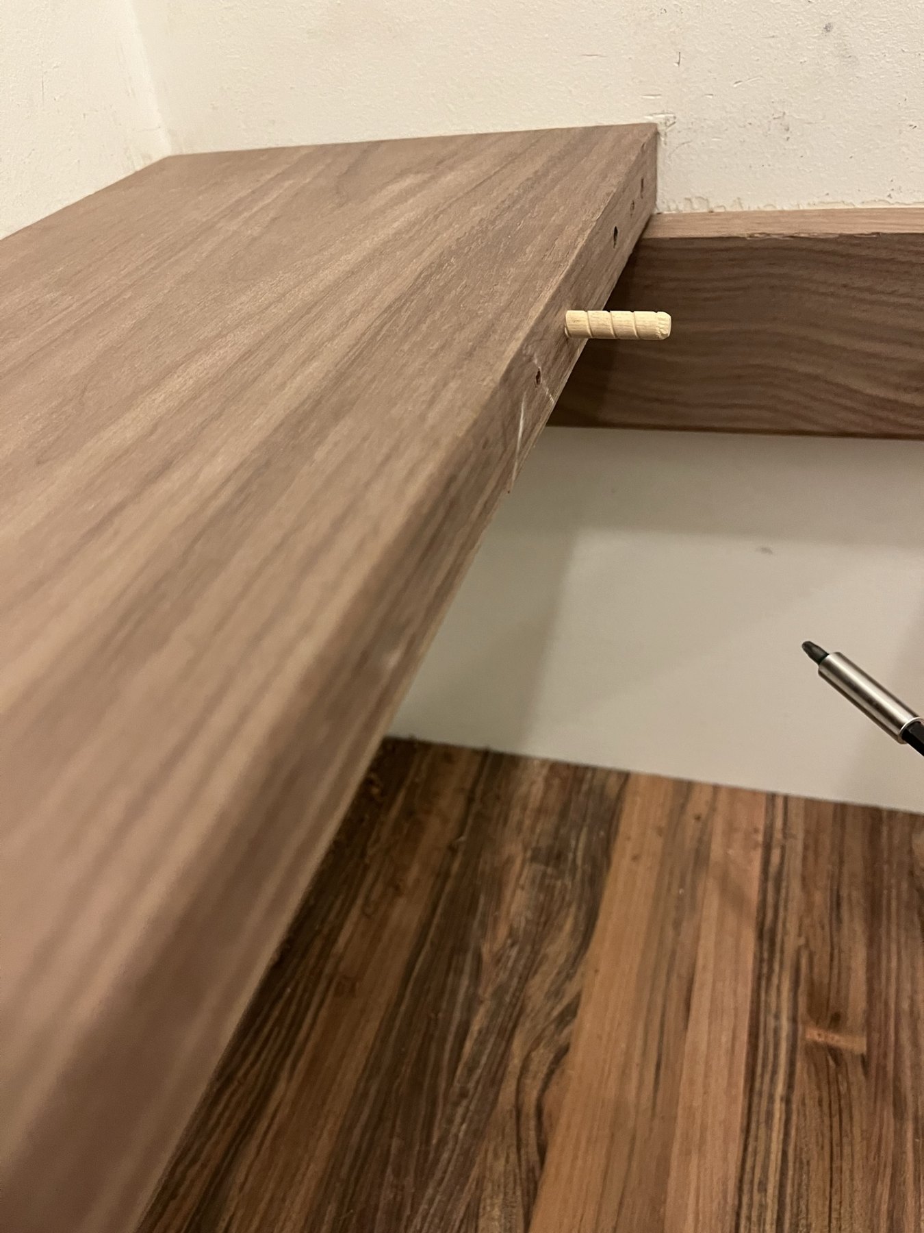 Walnut shelf section being fitted to its adjoining support