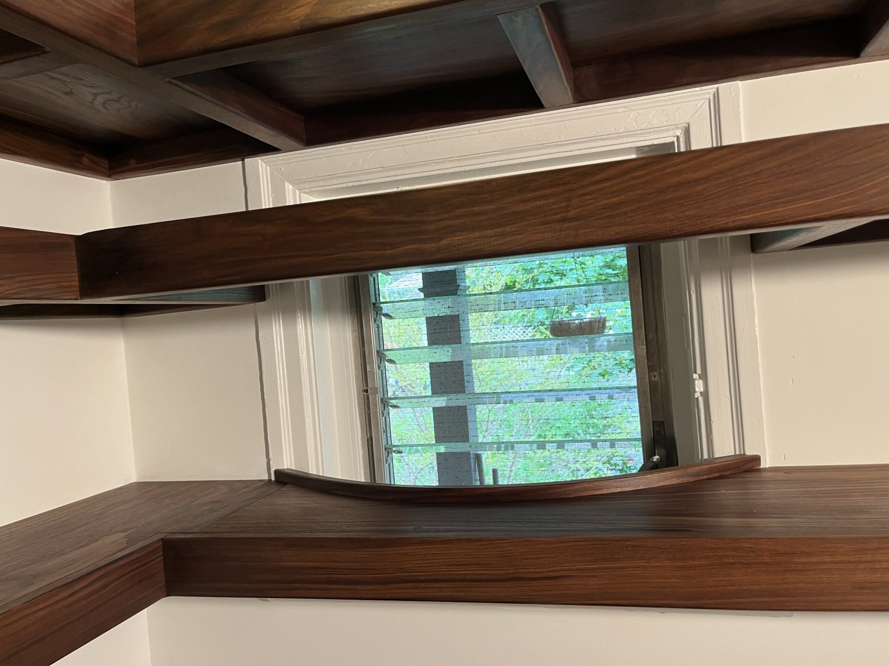 Walnut shelves curved back around the pantry window