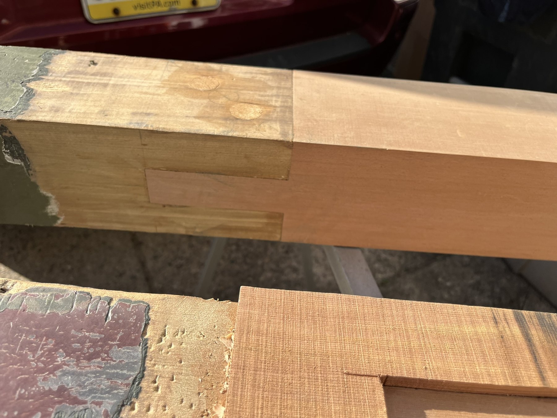 Close view of a cedar post repair with a wooden dowel