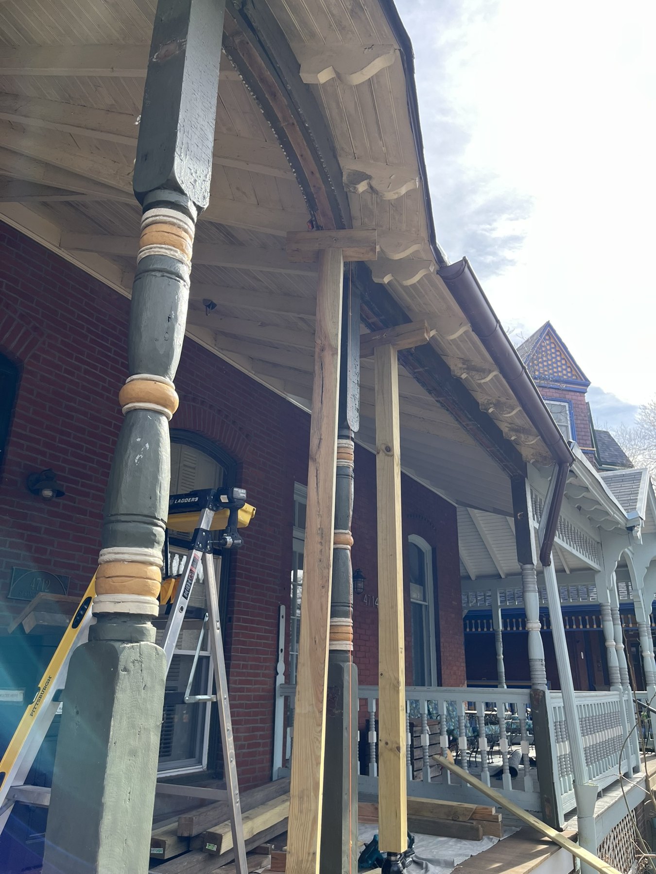 Temporary timber supports beneath the porch roof during restoration
