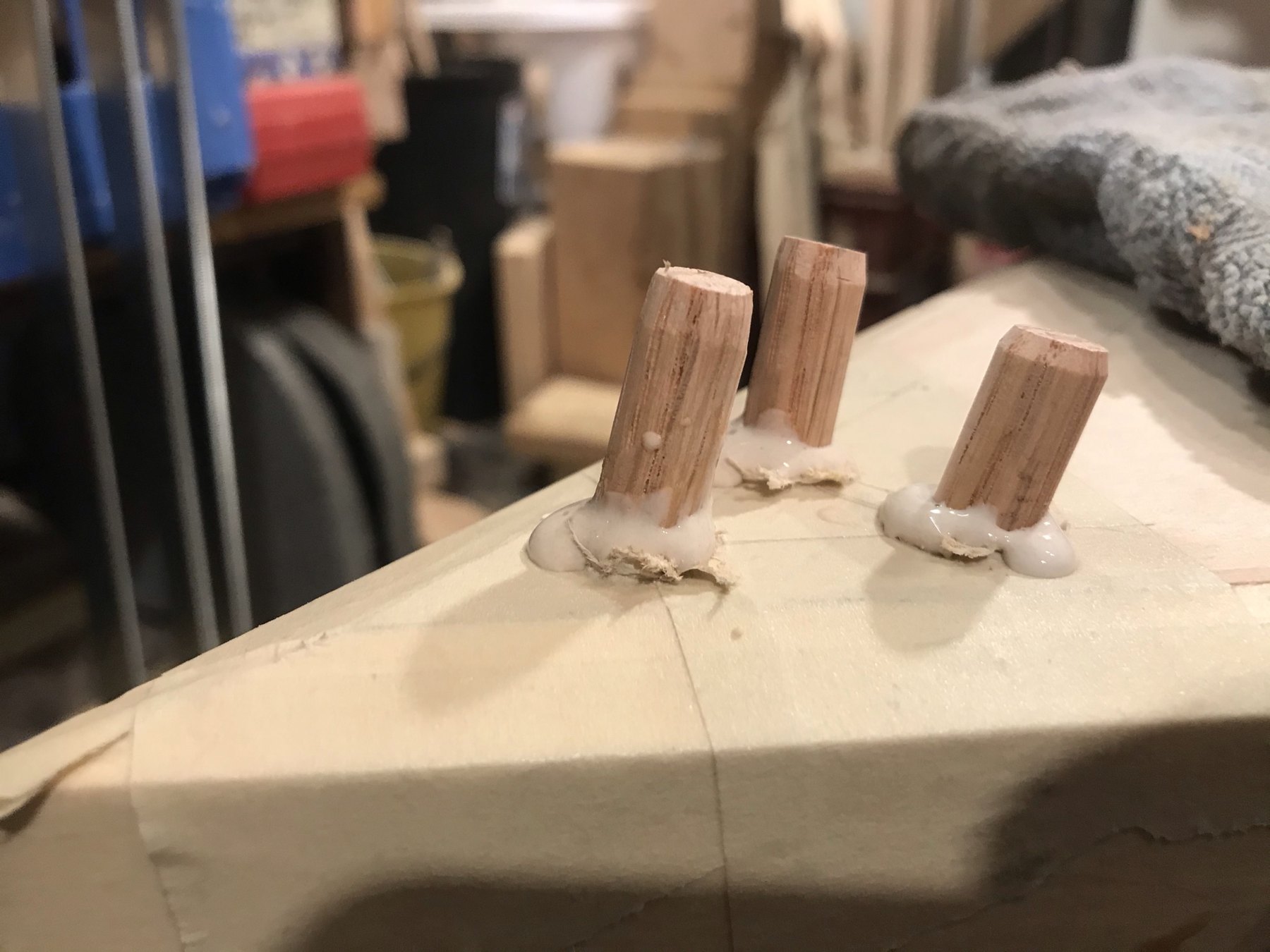 Wooden dowels projecting from a table component