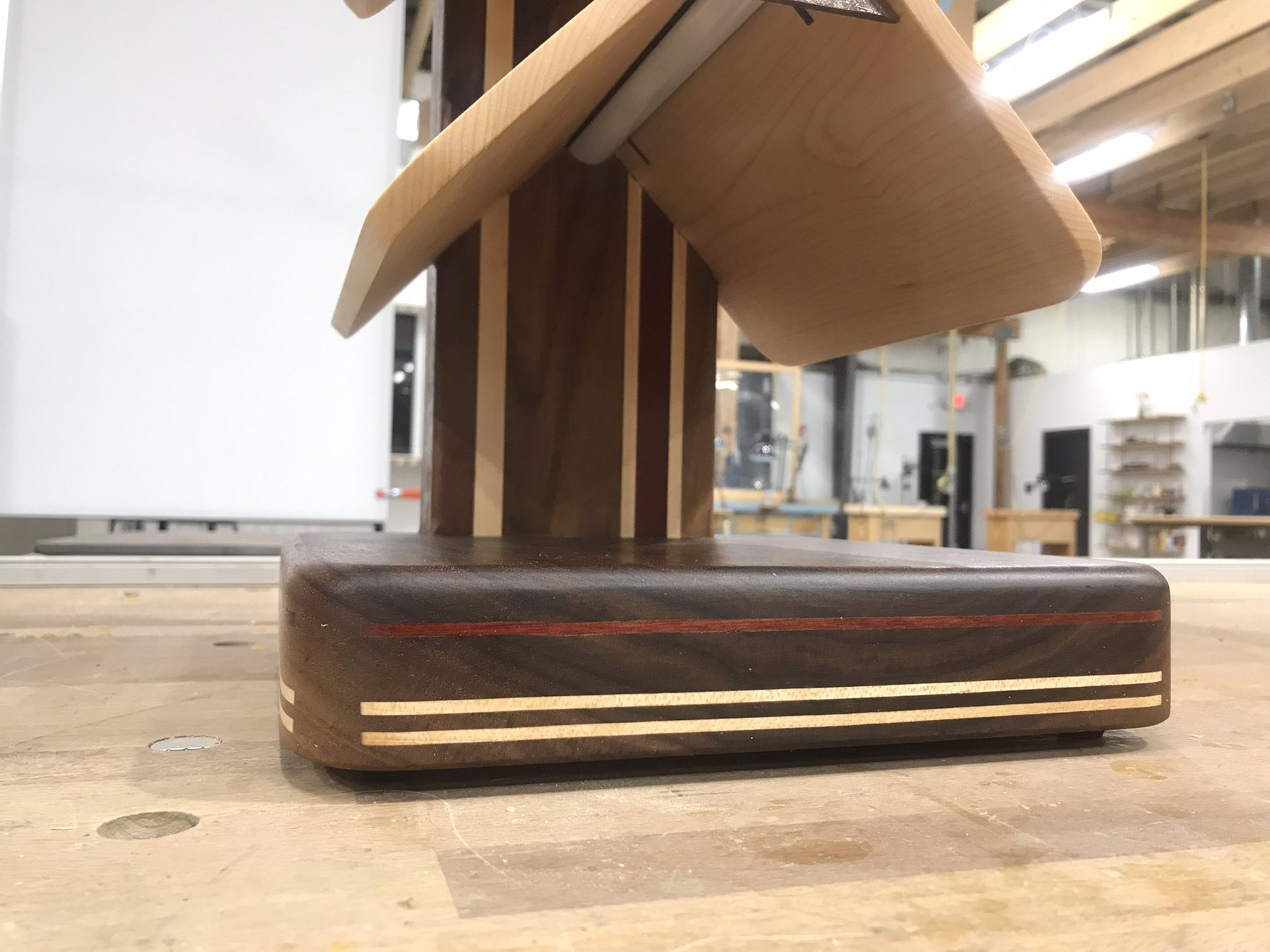 Close view of the shelf base with contrasting linear wood details